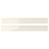 Two sleek, beige, high-gloss VOXTORP drawer fronts, made from fibreboard and melamine laminate, neatly aligned horizontally.