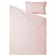 Blush pink bedding set with duvet and pillowcase made from soft cotton.