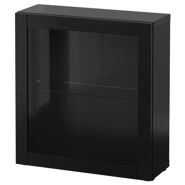 A black BESTÅ storage unit. Its square-shaped with a single glass door. The sleek design includes a glass shelf inside.