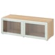 An ikea BESTÅ storage unit in oak effect and white with glass doors. Its rectangular with clean lines and sleek design.