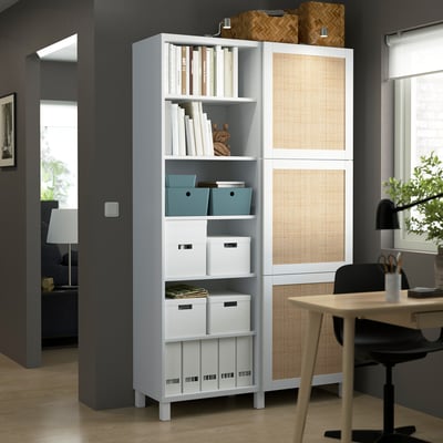 Modern BESTÅ storage unit in office with mixed shelves and natural light.