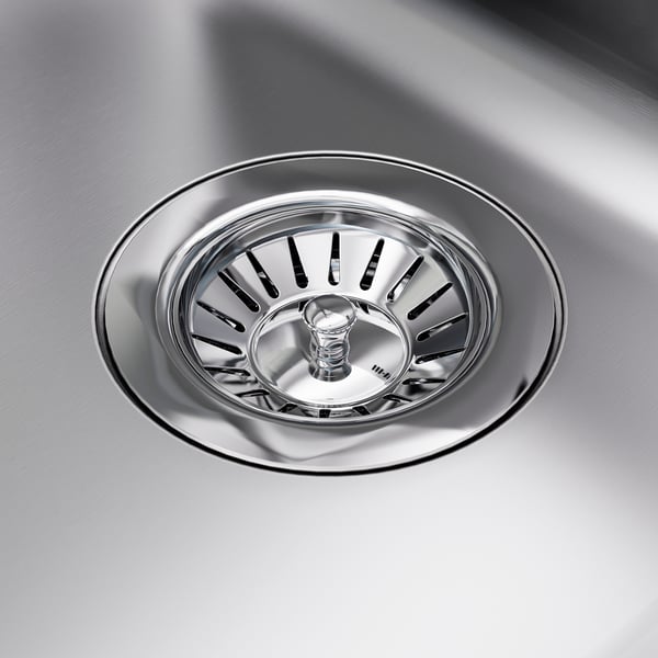Stainless steel sink drain, clean, durable, with intricate slotted design.