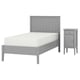 A modern grey single bed and bedside table. The bed has a white mattress and wooden headboard. The bedside table has one drawer.