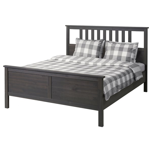 Modern dark grey wooden bed with sleek headboard, chequered pillows and comfy grey quilt. Classic rectangular shape with clean lines.
