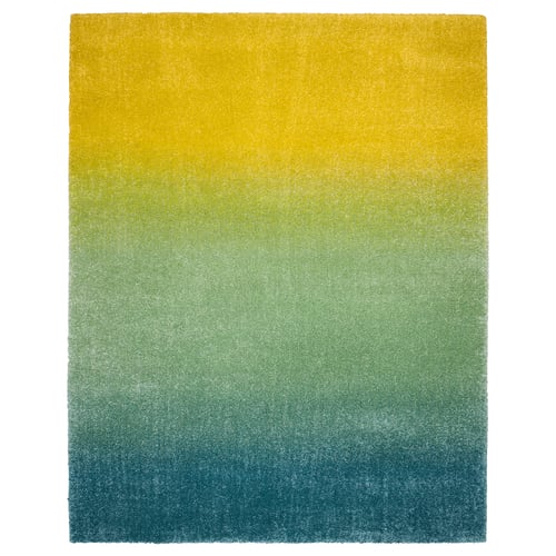 Rectangular, colourful rug: yellow, green, blue gradient, soft pile.