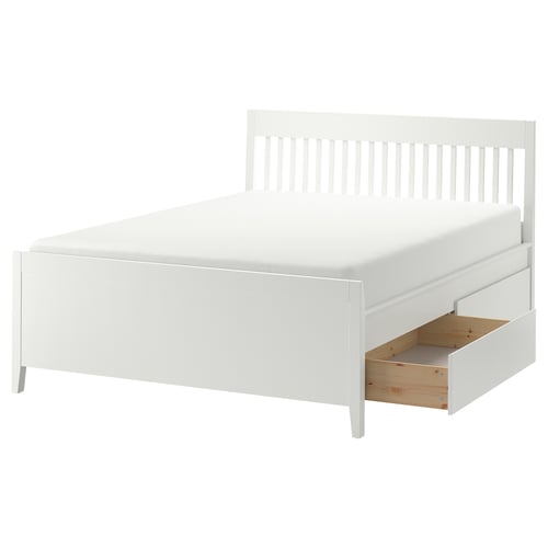 IDANÄS white bed with storage drawers and wooden legs.