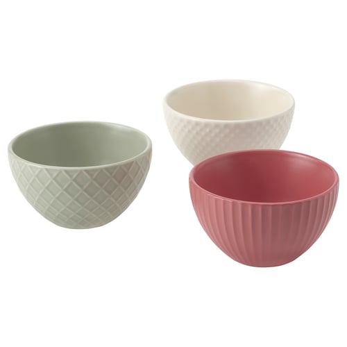 Three ceramic bowls in green, white, and red; textured designs.