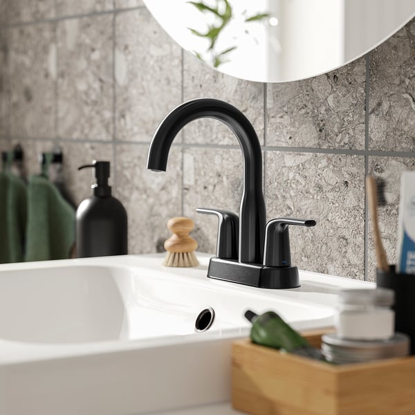 Black wash-basin tap with sleek, curved design for modern bathroom.