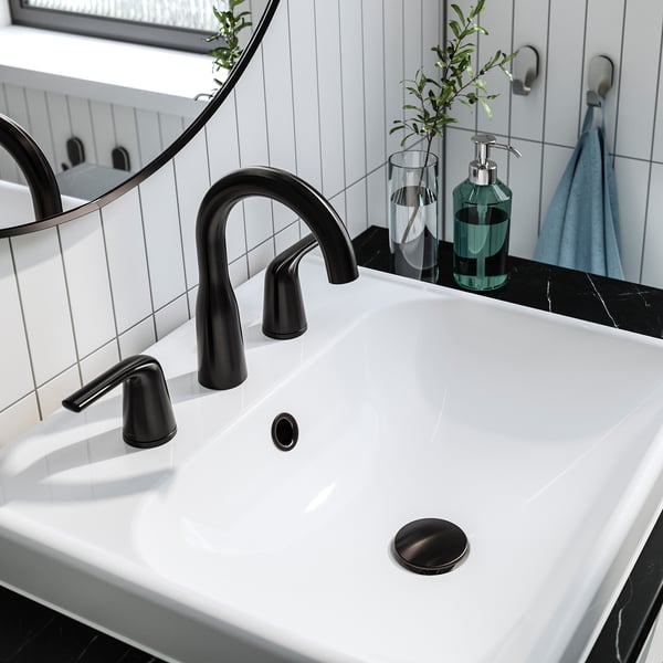 Black tap with curved spout on white sink, featuring modern design and efficient water flow.