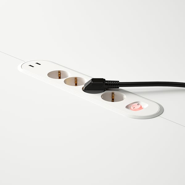 Modern conference table power unit with multiple outlets and usb ports, integrated into white tabletop.