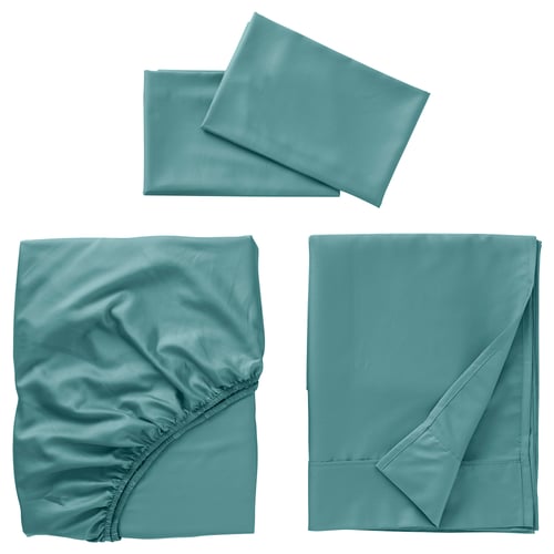 Three pieces of teal bedding: two flat sheets, one slightly crumpled with elastic, one folded neatly; all smooth, silky texture.