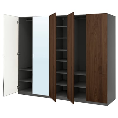 An open PAX wardrobe in dark wood and white, featuring shelves and a mirror.