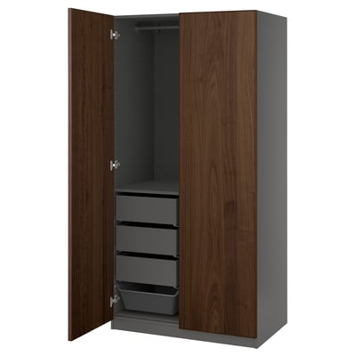 An open PAX wardrobe in dark brown with three grey drawers and a hanging rod.