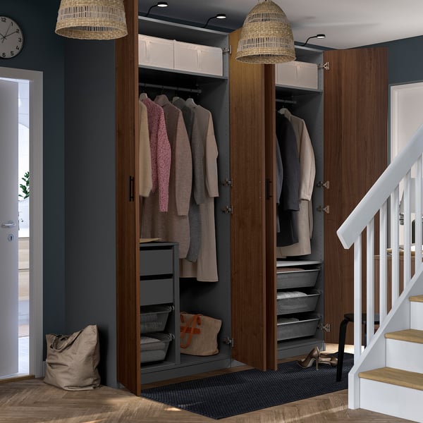 Modern closet with clothes, shelves, and drawers in a stylish room.