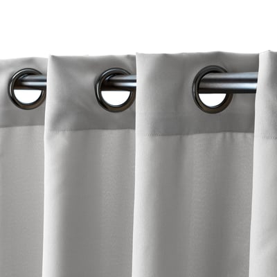 Curtains with metal eyelet headings, providing privacy and reducing glare, hanging from silver rod.