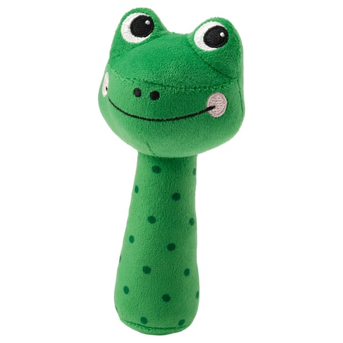 Green frog-shaped baby rattle with a smile, large round eyes, and dark spots on its body. Made of soft, recycled materials.