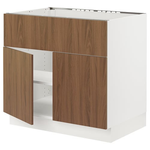Modern white SEKTION kitchen cabinet with walnut doors, minimalist design, one ajar revealing shelf.