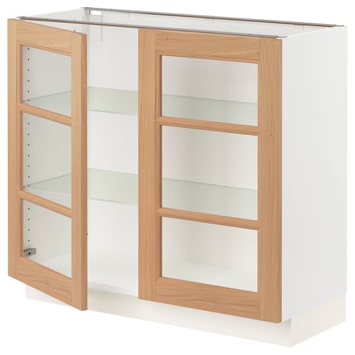 SEKTION kitchen unit with oak doors and glass shelves.
