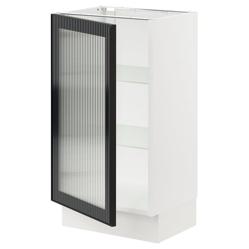 A modern white kitchen cabinet with a black glass door featuring a metal frame and vertical reeded texture.