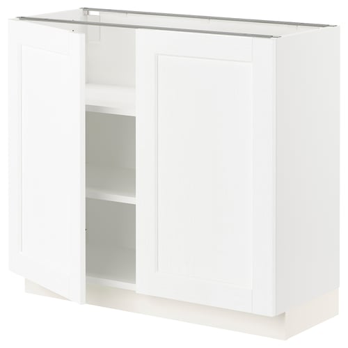 White kitchen cabinet with one open door revealing shelves, featuring clean design.