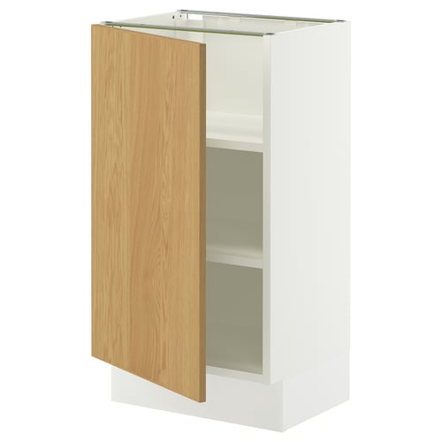 A white SEKTION cabinet with an oak veneer door slightly open, revealing an adjustable shelf inside.