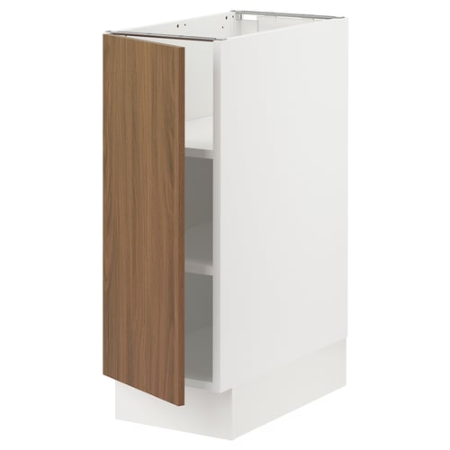 White SEKTION kitchen cabinet with walnut door, slightly ajar, adjustable shelves inside.