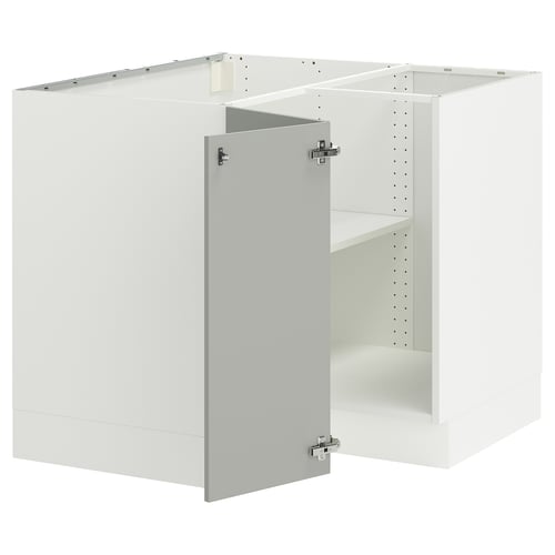 An assembled white SEKTION kitchen cabinet set with a light grey door featuring silver hinges.