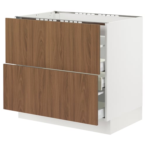 An ikea SEKTION kitchen cabinet with walnut-colored tistorp drawers. Its white and rectangular with smooth surfaces and modern design.