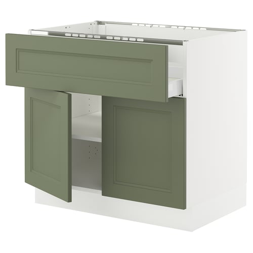 Modern olive green kitchen cabinet with white interior, open doors, and adjustable shelf.