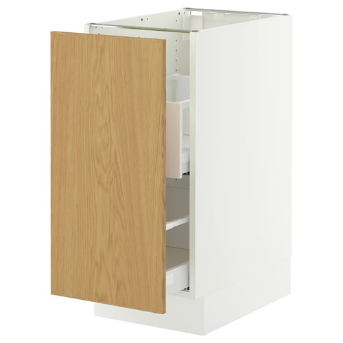 A SEKTION white cabinet with a light oak door partially open, revealing storing compartments.