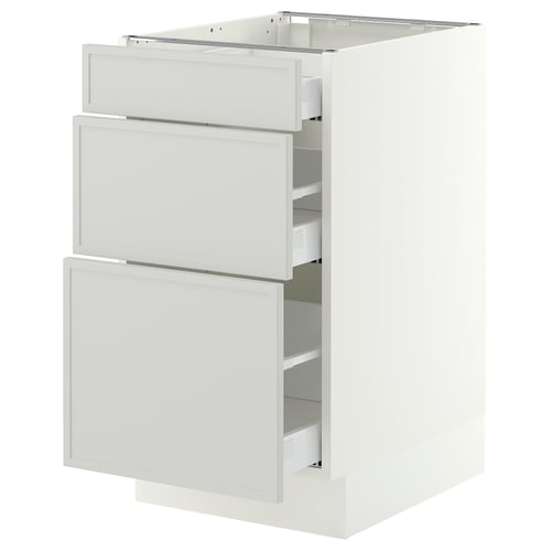 A white IKEA SEKTION kitchen base cabinet with three light grey drawers. Its modern, rectangular, and minimalist.