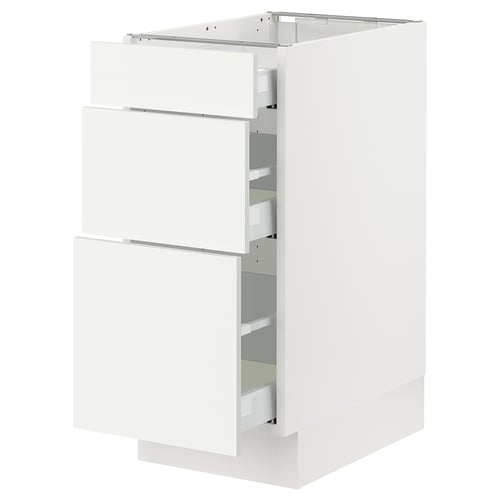 White SEKTION cabinet with three open drawers.