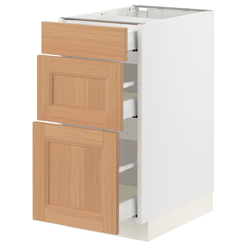 An ikea SEKTION white base cabinet with oak drawers and a door. It has a modern design with three wooden drawers and one wooden door.