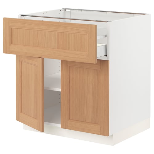SEKTION kitchen unit in oak. Open door, shelf, and drawer. White base, light wood finish. Modern, functional design.