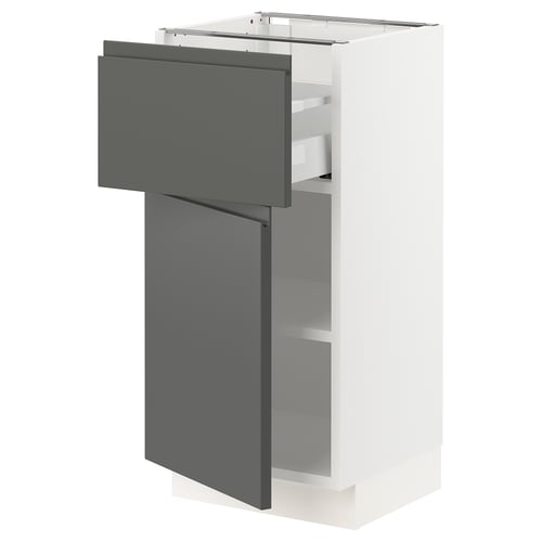Modern dark grey ikea SEKTION kitchen cabinet with open drawer and metal racks.