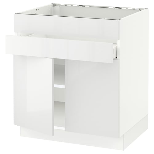 This image shows a white SEKTION kitchen cabinet with a glossy finish and adjustable shelves.