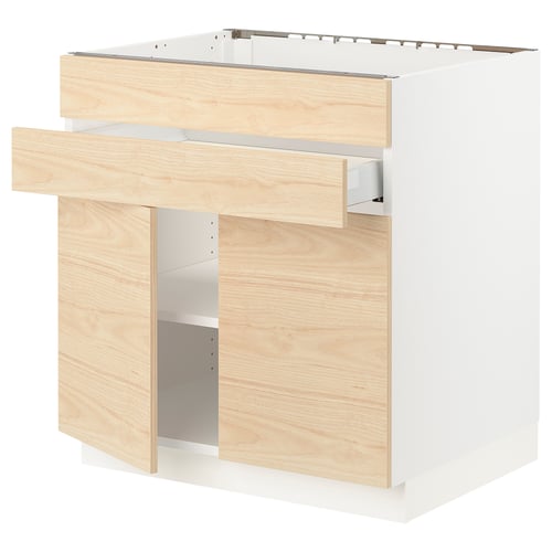 Modern kitchen cabinet with light ash wood drawers and white frame.