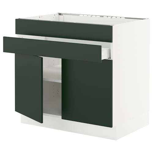 Modern green-white kitchen cabinet with drawers and shelves, angled view.