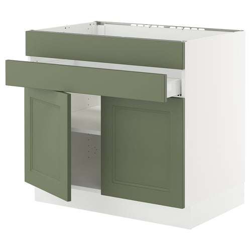 Green kitchen cabinet with drawers & shelves, modern design.