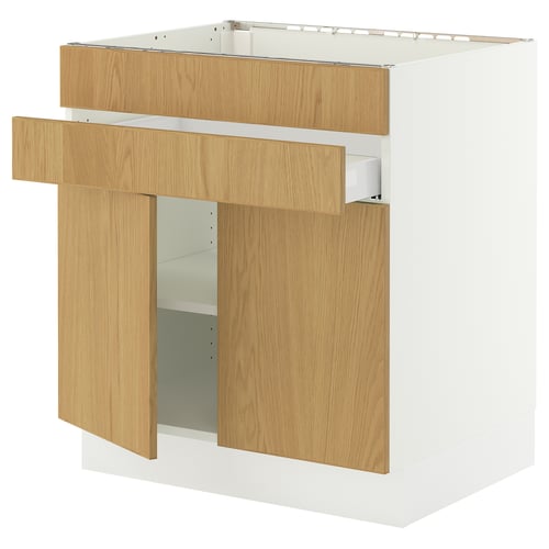 SEKTION, a modern kitchen cabinet in light oak wood, featuring a drawer with a wooden handle and open shelves, mounted to a white frame.