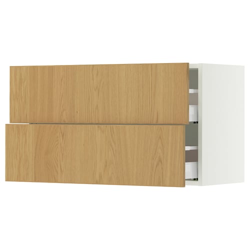 An ikea SEKTION cabinet with light oak wood drawers and white frame. It has two open drawers revealing organized interiors.