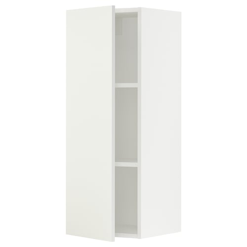 A white SEKTION kitchen cabinet with one open door, revealing two shelves.