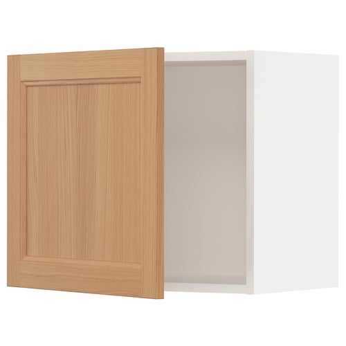 A light wooden cabinet door and an empty white cabinet. The door is made of oak with a natural finish, and the cabinet is white.