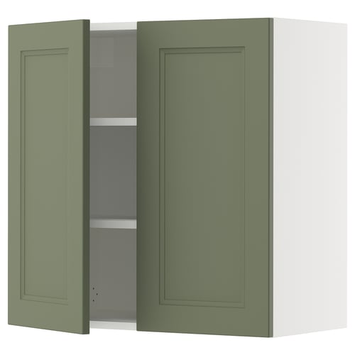 Green kitchen cabinet, SEKTION brand, wall-mounted with two doors, one open revealing shelves. Simple, modern design.