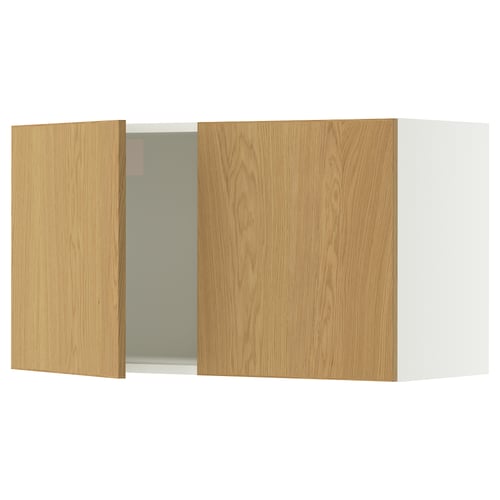 A light wooden kitchen wall cabinet with two doors. One door is slightly open.