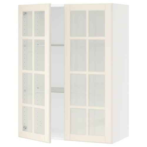 A white SEKTION kitchen unit with glass doors. It has a traditional design, featuring bevelled edges on the glass doors and adjustable shelves.