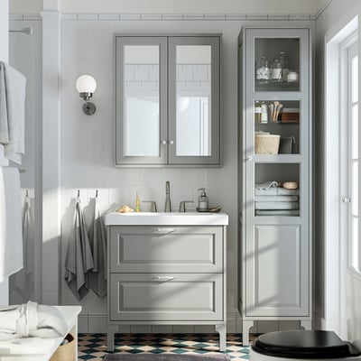 Grey TÄNNFORSEN bathroom set: large drawers, ceramic sink, wall-mounted cabinet, classic design with bevelled edges.