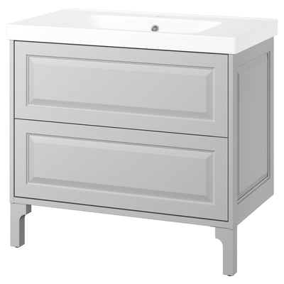 Light grey TÄNNFORSEN vanity with 2 drawers, ceramic basin, sleek edges.
