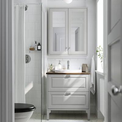 TÄNNFORSEN grey bathroom vanity with white sink. Modern design, 2 drawers, mirror cabinet above.