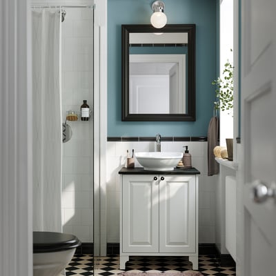 TÄNNFORSEN vanity in stylish bathroom with mirror, storage, basin, and shower.